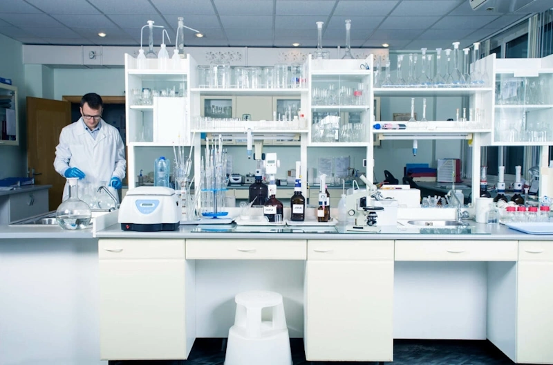Biotech lab with researchers analyzing data on computer screens